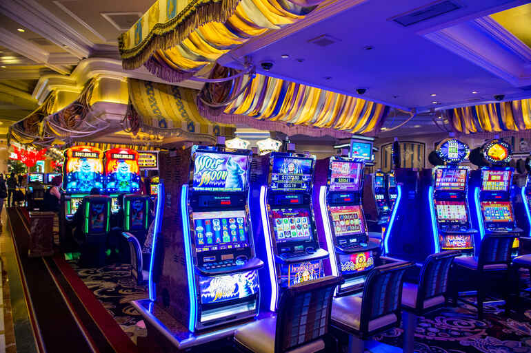 Neon-lit casino slot machines in a vibrant gaming hall